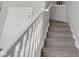 Carpeted stairway with white railing at 9730 Prairie Smoke Dr, Noblesville, IN 46060