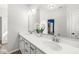 This bathroom has dual sinks, granite counters, a large mirror, and modern fixtures for a stylish touch at 1004 Astor Ln, Carmel, IN 46032