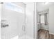 Bright bathroom featuring white subway tiles, frameless shower glass and luxury plank flooring at 1004 Astor Ln, Carmel, IN 46032