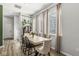 Bright dining area featuring a wooden table, stylish chairs, large windows with natural light, and modern decor at 1004 Astor Ln, Carmel, IN 46032