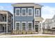 Charming blue two-story home featuring a welcoming front door with a decorative wreath and a neat, fenced yard at 1004 Astor Ln, Carmel, IN 46032