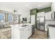 Open-concept kitchen with island, stainless steel appliances, and seamless flow to the living area at 1004 Astor Ln, Carmel, IN 46032