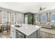 Bright kitchen island with quartz counters, stainless appliances, and adjacent dining area at 1004 Astor Ln, Carmel, IN 46032