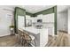 Open kitchen with white cabinets, a large island with seating, and modern appliances, perfect for Gathering gatherings at 1004 Astor Ln, Carmel, IN 46032