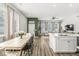 Open-concept living area with a modern dining table, kitchen island, and ample natural light at 1004 Astor Ln, Carmel, IN 46032