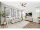 Inviting living room features a comfortable sofa, stylish decor, and ample natural light from large windows at 1004 Astor Ln, Carmel, IN 46032