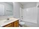 Standard bathroom with shower-tub combo and vanity with wood colored cabinets at 10046 Gate Dr, Indianapolis, IN 46239