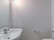This bathroom has a white pedestal sink and a simple, modern design at 10046 Gate Dr, Indianapolis, IN 46239