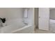 Bright bathroom featuring a soaking tub with tile surround at 10046 Gate Dr, Indianapolis, IN 46239