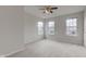 This bedroom features neutral carpet and multiple windows at 10046 Gate Dr, Indianapolis, IN 46239