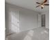 This bedroom has neutral carpet with a window and interior door at 10046 Gate Dr, Indianapolis, IN 46239