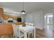 This dining area has a modern white table and is adjacent to the kitchen at 10046 Gate Dr, Indianapolis, IN 46239