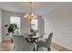 A dining room featuring a table, chairs, a chandelier, and a houseplant at 10046 Gate Dr, Indianapolis, IN 46239