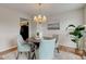 A dining room featuring a table, chairs, a chandelier, and a modern painting at 10046 Gate Dr, Indianapolis, IN 46239