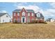 Charming two-story red brick home with classic architectural details and a well-maintained lawn at 10046 Gate Dr, Indianapolis, IN 46239