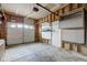 Unfinished garage featuring overhead garage door, side door, and concrete flooring at 10046 Gate Dr, Indianapolis, IN 46239