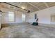 Spacious two-car garage with concrete floor, overhead door, and side door for easy access at 10046 Gate Dr, Indianapolis, IN 46239