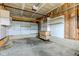 Unfinished garage featuring built in white shelves with storage and concrete flooring at 10046 Gate Dr, Indianapolis, IN 46239
