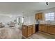 Open-concept kitchen with a bar that has wood cabinets and a large living room space at 10046 Gate Dr, Indianapolis, IN 46239