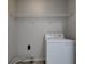 The laundry room features a washing machine, a shelf and simple amenities at 10046 Gate Dr, Indianapolis, IN 46239