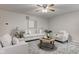 Bright living room with a comfortable seating area, stylish rug, and ceiling fan at 10046 Gate Dr, Indianapolis, IN 46239