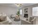 Cozy living room with fireplace, neutral furniture, and lots of natural light at 10046 Gate Dr, Indianapolis, IN 46239