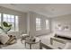 Bright main bedroom featuring sitting area, large windows and plush neutral decor at 10046 Gate Dr, Indianapolis, IN 46239
