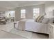 Bright main bedroom featuring sitting area, large windows and plush neutral decor at 10046 Gate Dr, Indianapolis, IN 46239
