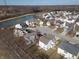 An aerial view highlights the neighborhood near a pond and well maintained homes at 10725 Chenille Ct, Indianapolis, IN 46235