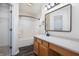 Bathroom features a shower-tub combo, wood-look floors, and a white vanity at 10725 Chenille Ct, Indianapolis, IN 46235