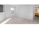 Bright bedroom features a neutral palette, window, and access to an ensuite bathroom at 10725 Chenille Ct, Indianapolis, IN 46235