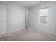 A bright bedroom features neutral carpet, pale blue walls, and a window with natural light at 10725 Chenille Ct, Indianapolis, IN 46235