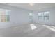 Spacious bedroom with plush carpet, light walls and multiple windows at 10725 Chenille Ct, Indianapolis, IN 46235