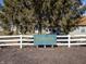 Welcoming entrance to Briarbrook Farm with a charming sign and white picket fence, offering a peaceful community setting at 10725 Chenille Ct, Indianapolis, IN 46235