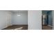 Open-concept dining room with hardwood flooring, a modern light fixture, and stainless steel refrigerator at 10725 Chenille Ct, Indianapolis, IN 46235