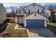 Two-story home with blue shutters, a large blue garage door, and a well-maintained lawn at 10725 Chenille Ct, Indianapolis, IN 46235