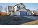 Two-story home with a well-manicured lawn and a two-car attached garage at 10725 Chenille Ct, Indianapolis, IN 46235