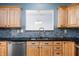 Updated kitchen featuring stainless steel appliances, wood cabinets and dark granite countertops at 10725 Chenille Ct, Indianapolis, IN 46235