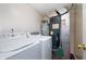 Functional laundry area with washer, dryer, and utilities in a well-maintained space at 10725 Chenille Ct, Indianapolis, IN 46235