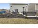 Backyard with a black mulch bed, patio set, hot tub, and fully fenced perimeter at 12486 Schoolhouse Rd, Fishers, IN 46037