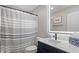 Well-lit bathroom with modern vanity, illuminated mirror, and stylish shower curtain at 12486 Schoolhouse Rd, Fishers, IN 46037
