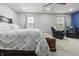 Bright bedroom with two chairs, a ceiling fan, and a bed with a patterned comforter at 12486 Schoolhouse Rd, Fishers, IN 46037