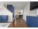 Inviting entryway showcasing hardwood floors and modern blue accent wall at 12486 Schoolhouse Rd, Fishers, IN 46037