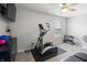 Exercise room with elliptical machine, free weights, and TV for a complete workout space at 12486 Schoolhouse Rd, Fishers, IN 46037