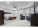 Spacious main bedroom with a fan, a bed with decorative pillows, and dark furniture at 12486 Schoolhouse Rd, Fishers, IN 46037