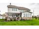 The backyard has a patio under a pergola, a brick-based sunroom addition, and a lush green lawn at 12624 Teaberry Ln, Carmel, IN 46032