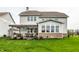 The backyard has a large green lawn, a sunroom addition with brick base, and a pergola-covered patio set at 12624 Teaberry Ln, Carmel, IN 46032