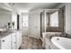 Well-lit bathroom featuring a bathtub, shower, and tiled floors at 12624 Teaberry Ln, Carmel, IN 46032