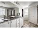 Bright bathroom featuring double sinks, granite countertops, and walk-in shower at 12624 Teaberry Ln, Carmel, IN 46032