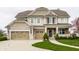 Charming two-story home with a three-car garage and manicured lawn at 12624 Teaberry Ln, Carmel, IN 46032